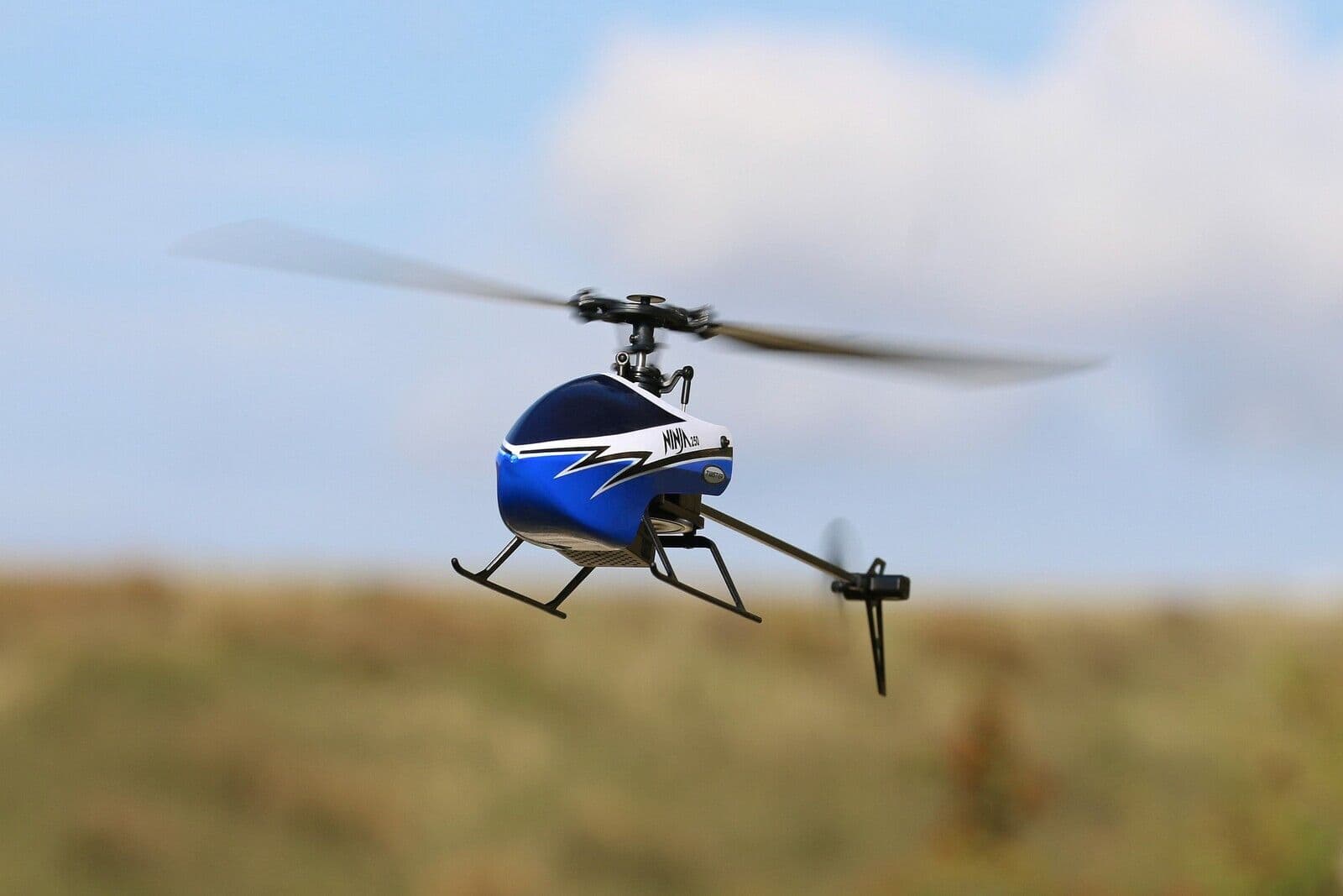 Blue radio-control helicopter in flight